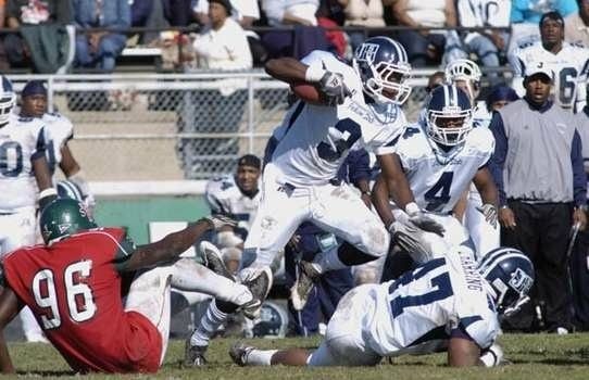 Ball carrier leaping over a tackle during a game